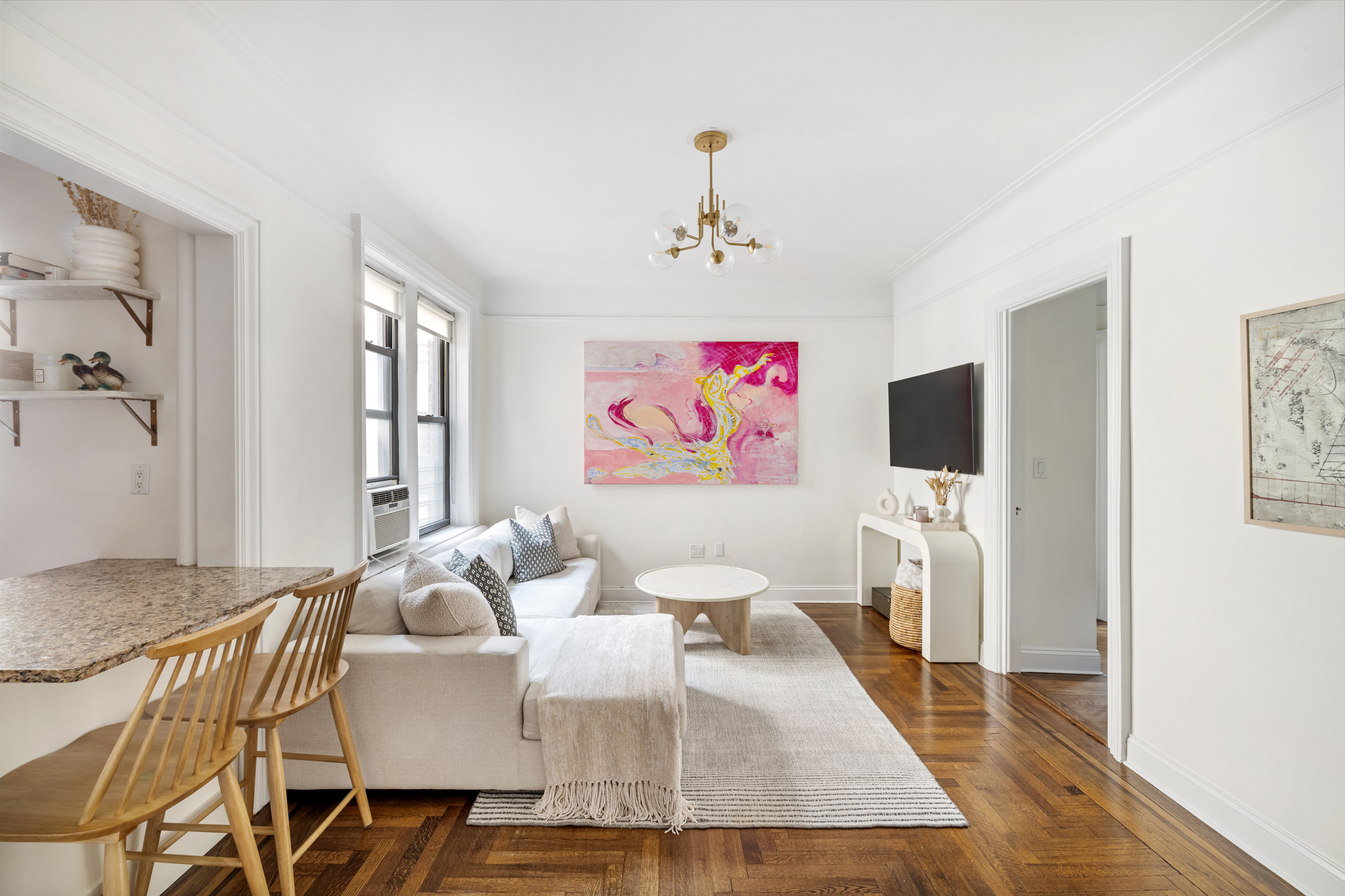 305 East 88th Street, Unit 4A Manhattan, NY 10128 - Photo 1 of 13 a living room with furniture and a flat screen tv