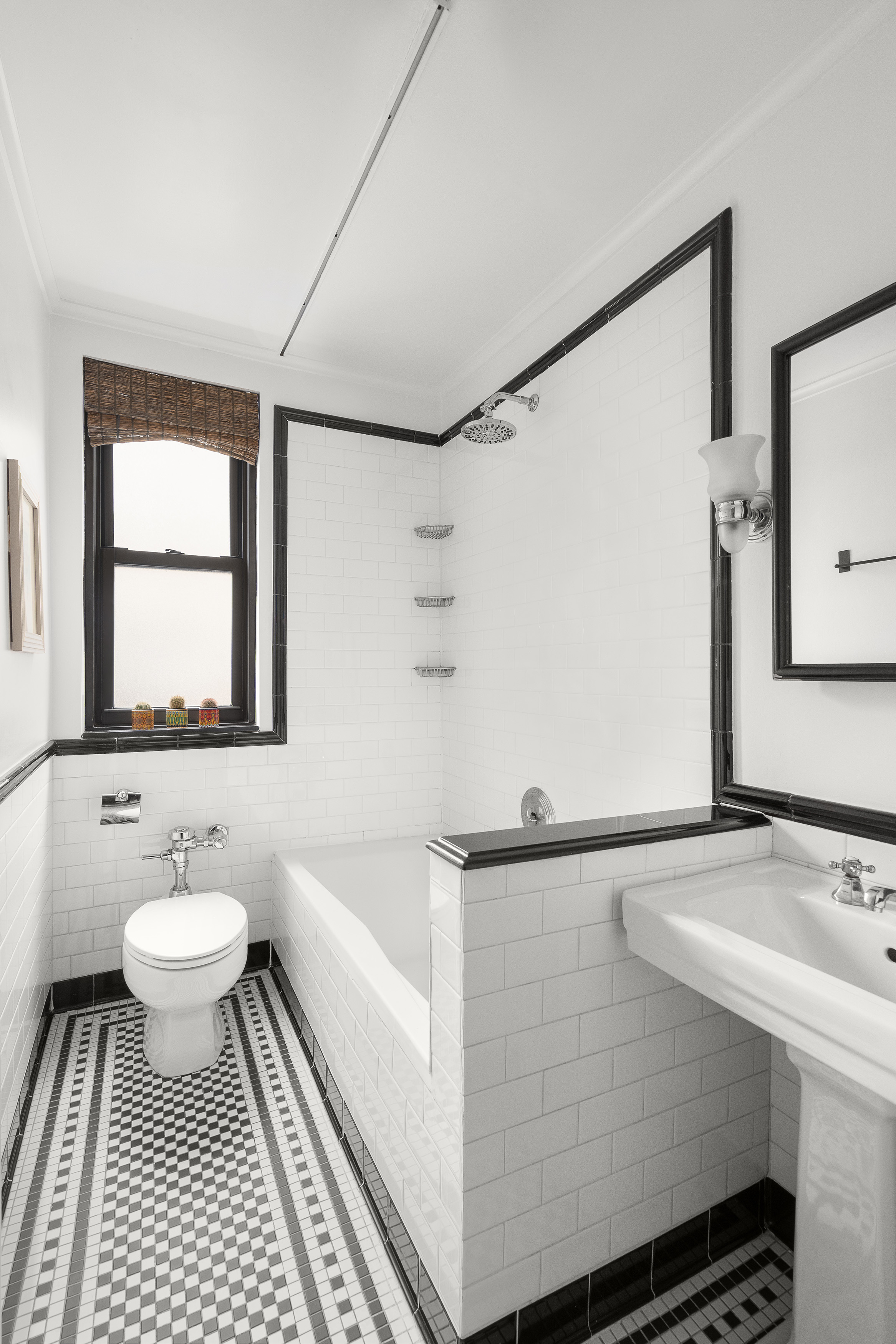 235 West End Avenue, Unit 8D Manhattan, NY 10023 - Photo 5 of 11 a bathroom with a sink toilet a mirror and vanity