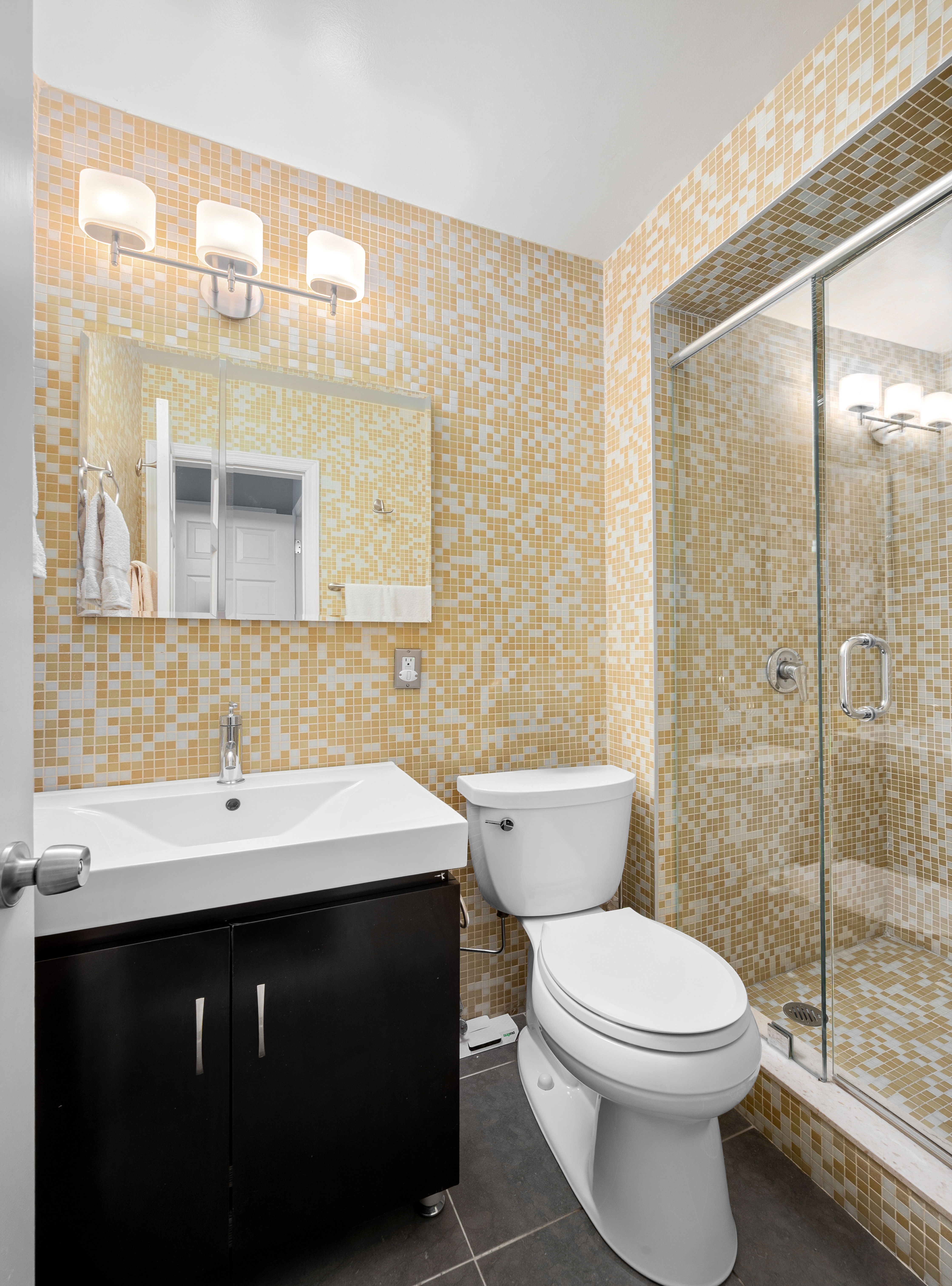 15 West 72nd Street, Unit 2C Manhattan, NY 10023 - Photo 6 of 9 a bathroom with a sink a toilet and shower