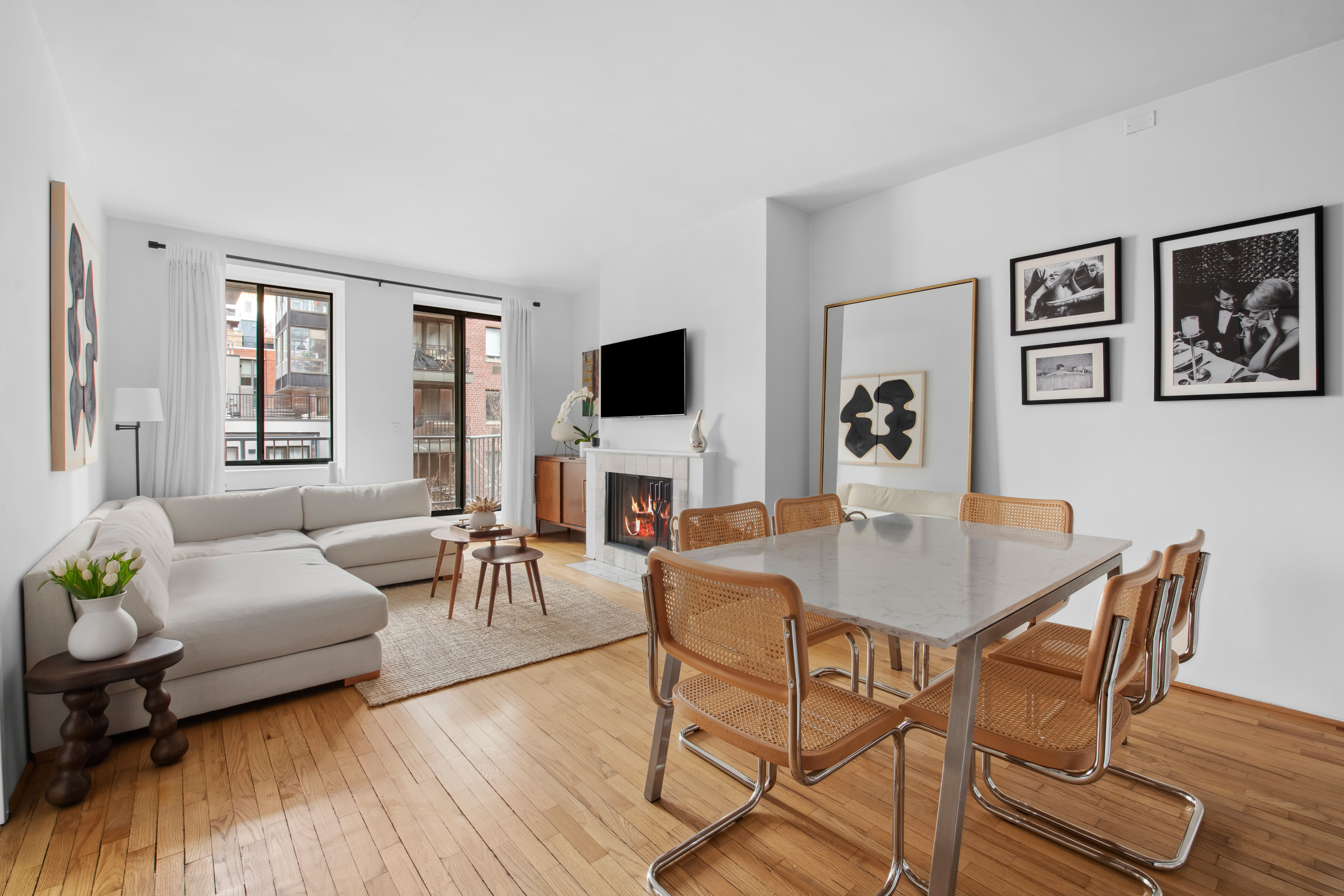 167 Perry Street, Unit 5H Manhattan, NY 10014 - Photo 1 of 8 a living room with furniture and a flat screen tv
