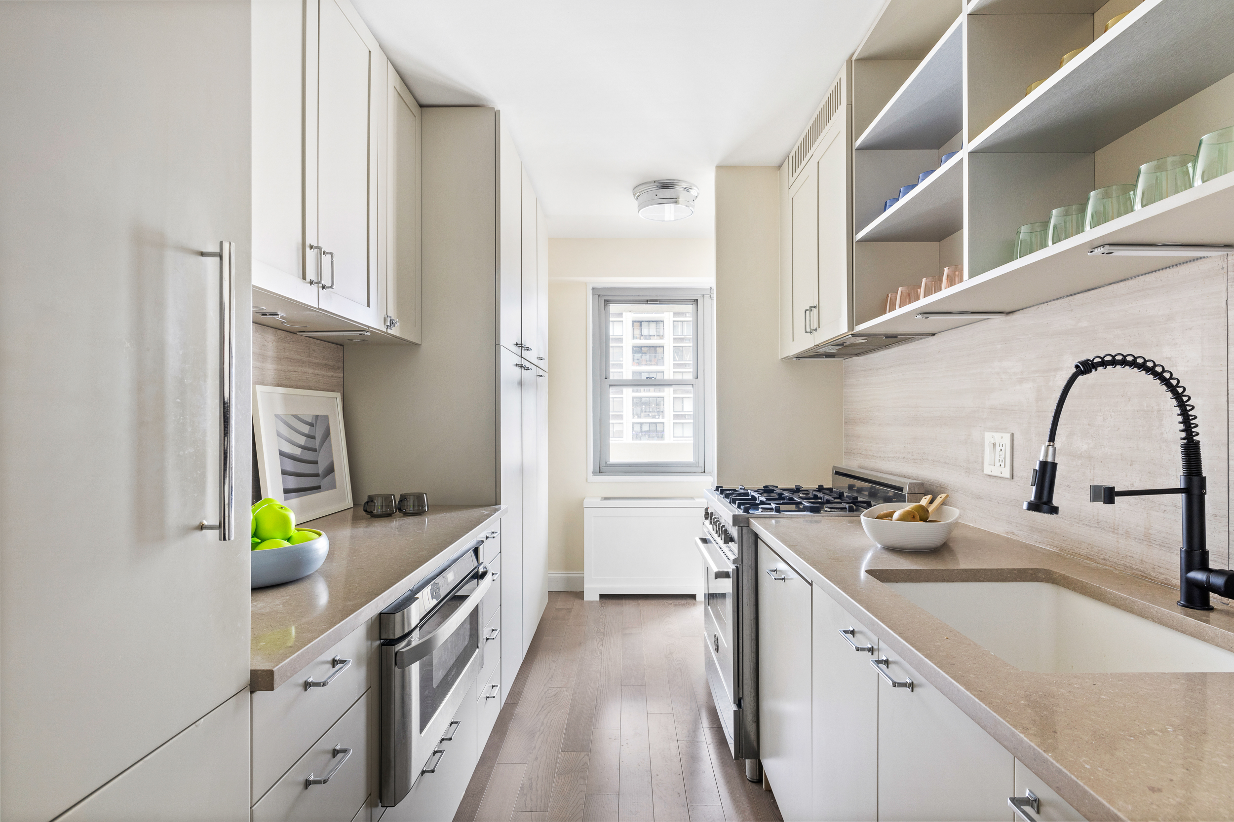 100 West 93rd Street, Unit 11J Manhattan, NY 10025 - Photo 2 of 13 a kitchen with stainless steel appliances granite countertop a sink and a stove