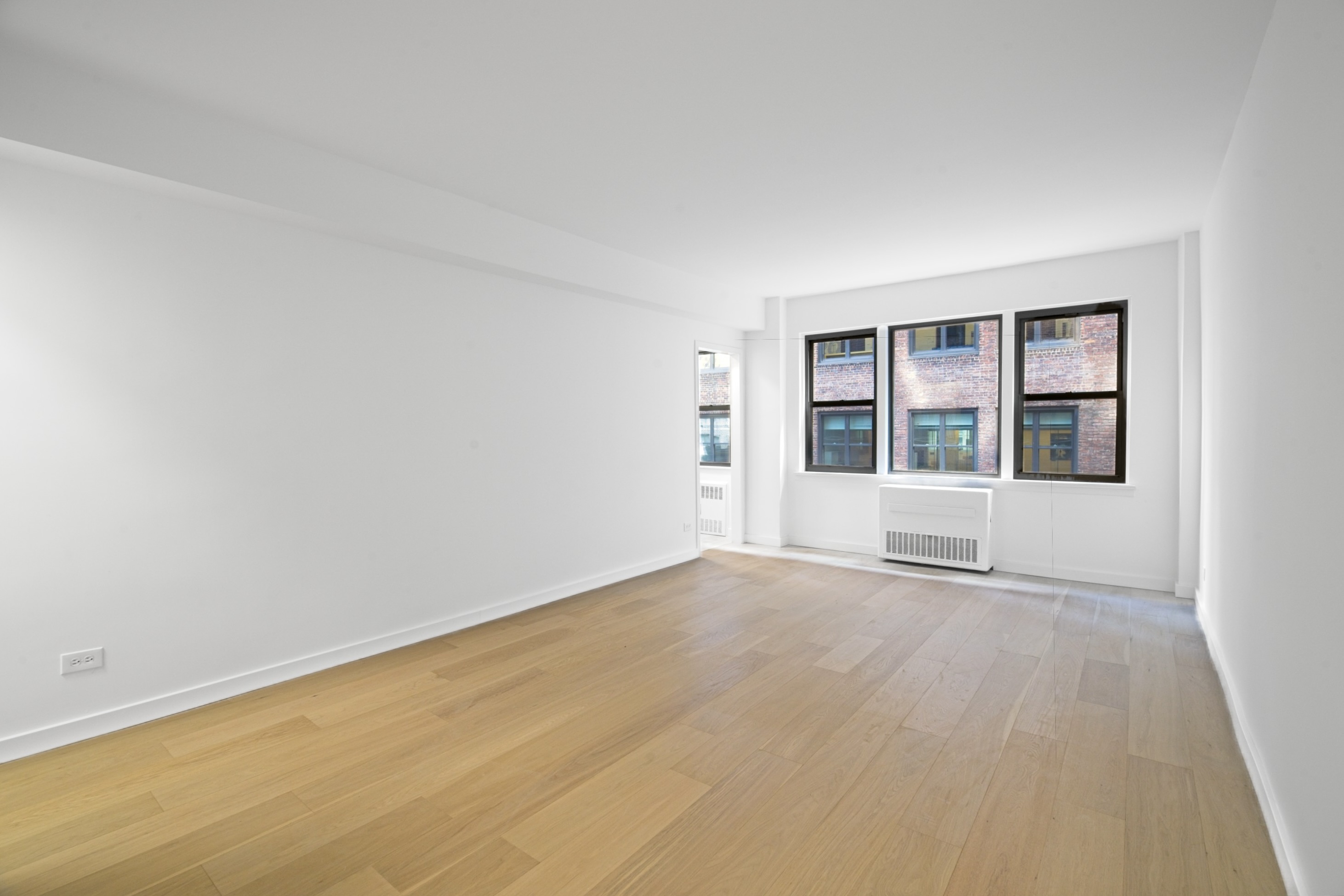 240 East 46th Street, Unit 8J Manhattan, NY 10017 - Photo 1 of 11 an empty room with a window