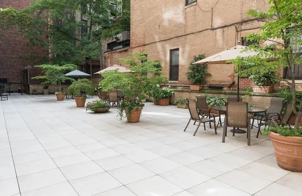 a view of a patio with table and chairs and potted plants