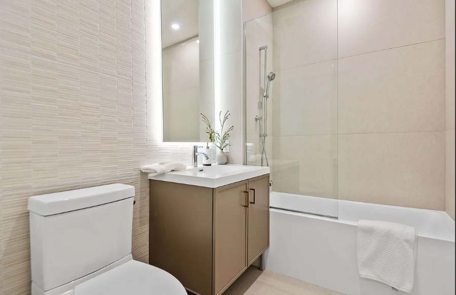 218 Front Street, Unit 231 Brooklyn, NY 11201 - Photo 10 of 35 a bathroom with a toilet sink and mirror