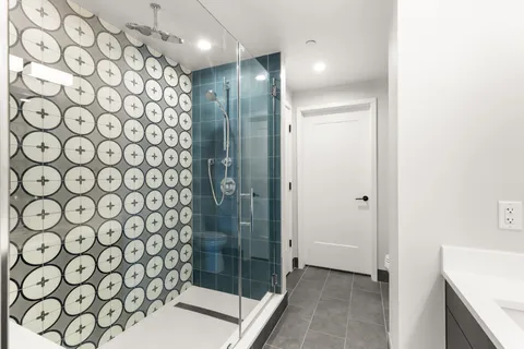 a bathroom with a shower and a sink