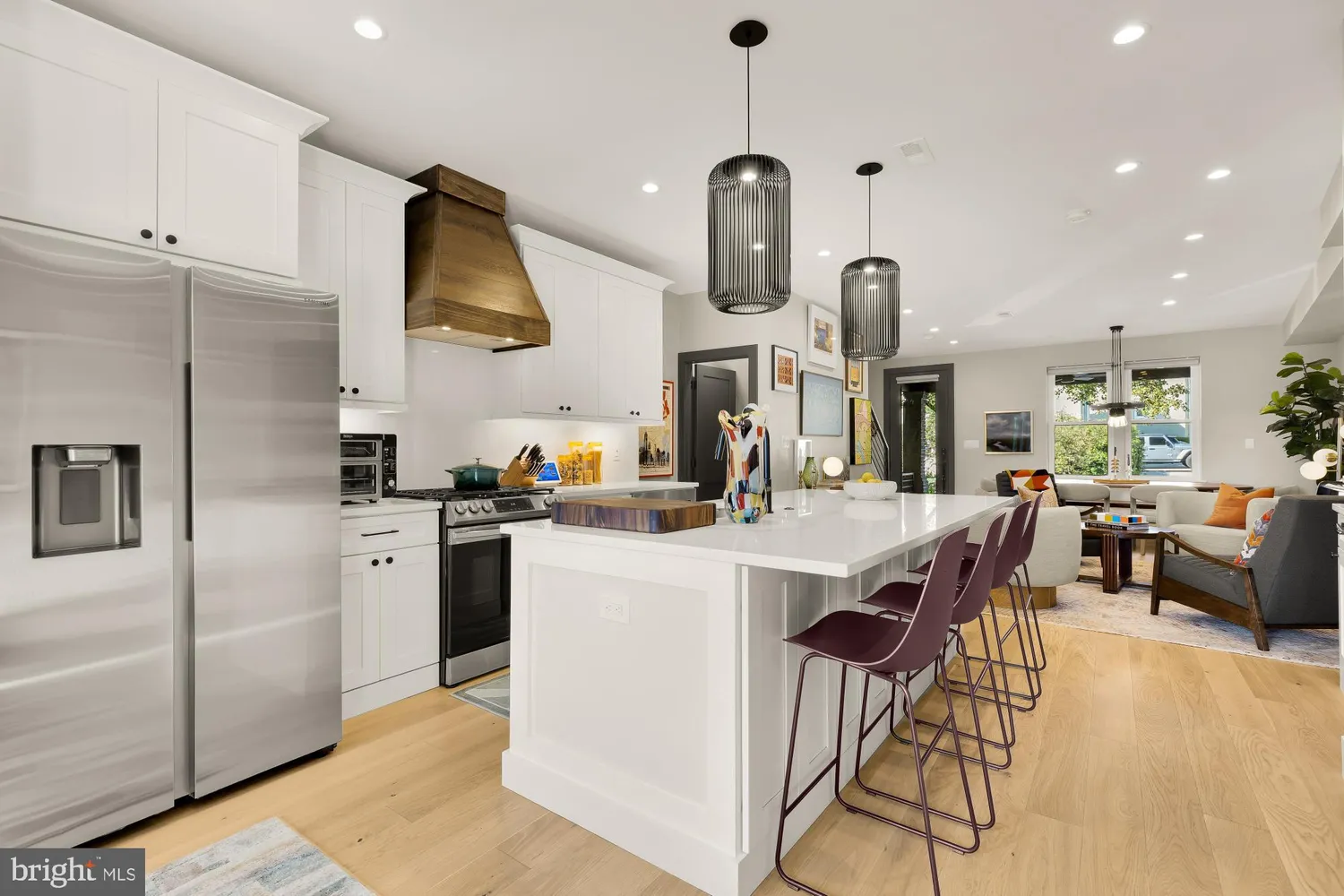 a kitchen with stainless steel appliances kitchen island granite countertop a sink a stove and refrigerator