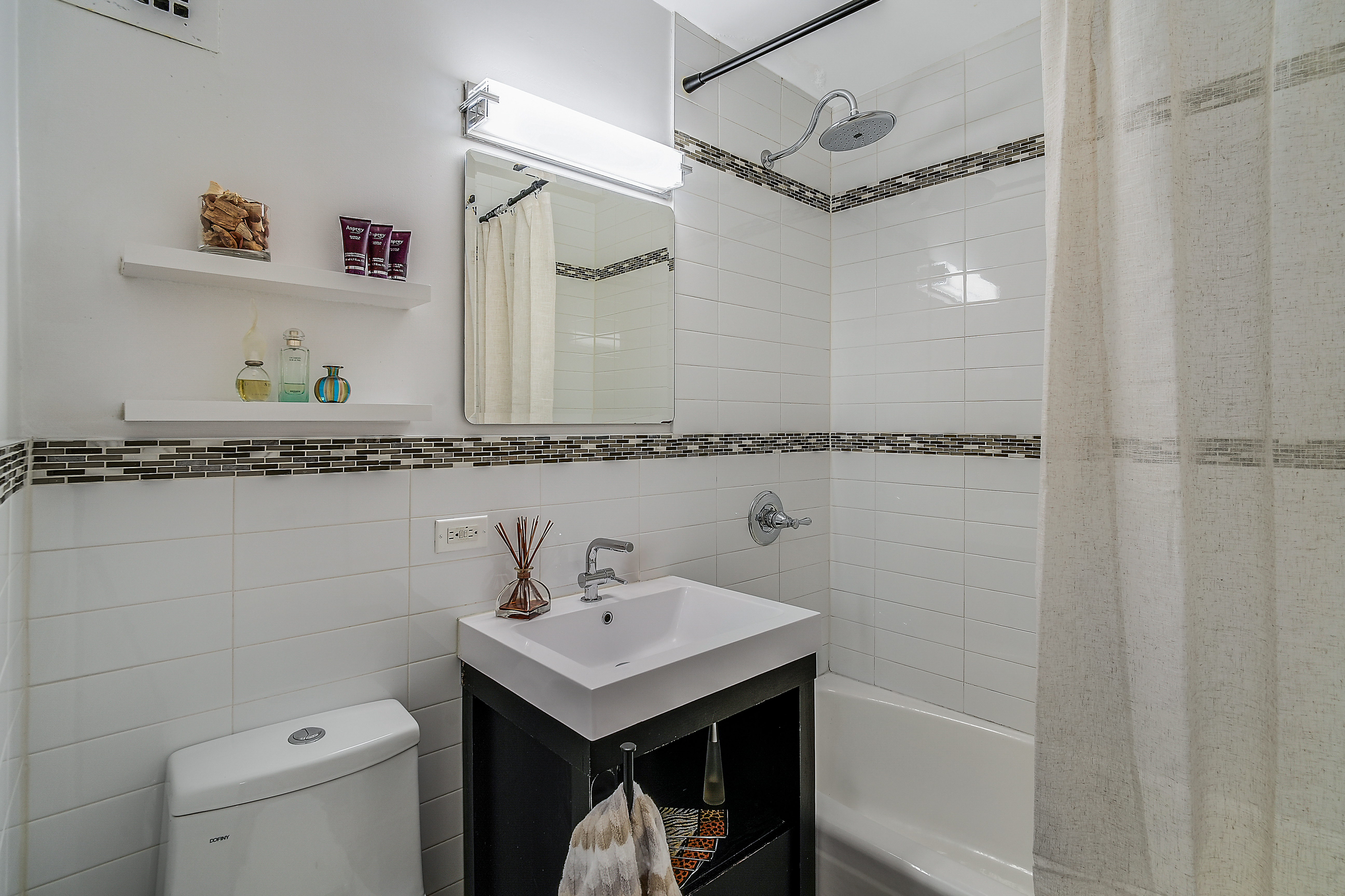 200 Central Park South, Unit 3F Manhattan, NY 10019 - Photo 7 of 9 a bathroom with a sink a toilet and shower