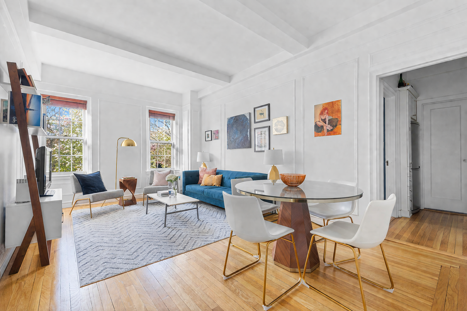 a living room with furniture and wooden floor