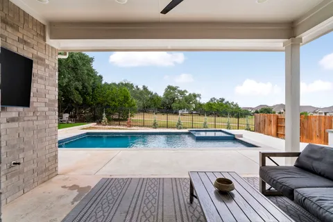 a view of a swimming pool with a lounge chair