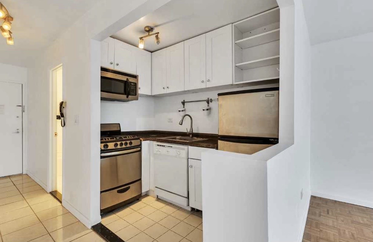 222 West 14th Street, Unit 5D Manhattan, NY 10011 - Photo 4 of 9 a kitchen with stainless steel appliances a sink and a refrigerator