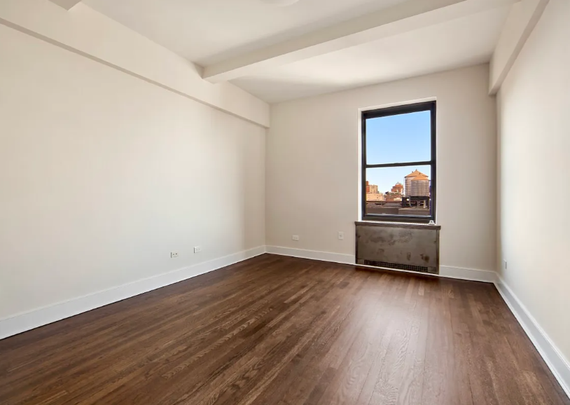 56 7th Avenue, Unit 19H Manhattan, NY 10011 - Photo 4 of 12 a view of empty room with wooden floor and fan