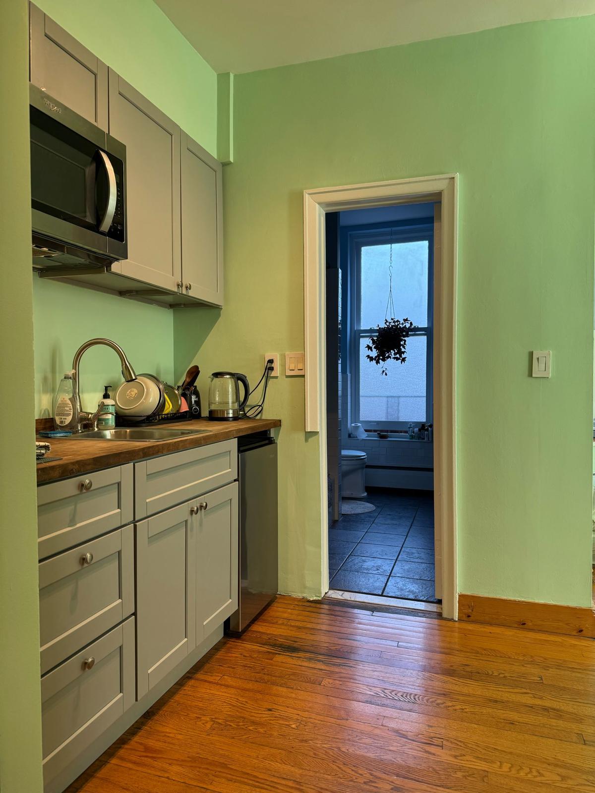 305 Washington Avenue, Unit B3 Brooklyn, NY 11205 - Photo 2 of 2 a kitchen with stainless steel appliances granite countertop a sink and cabinets with wooden floor