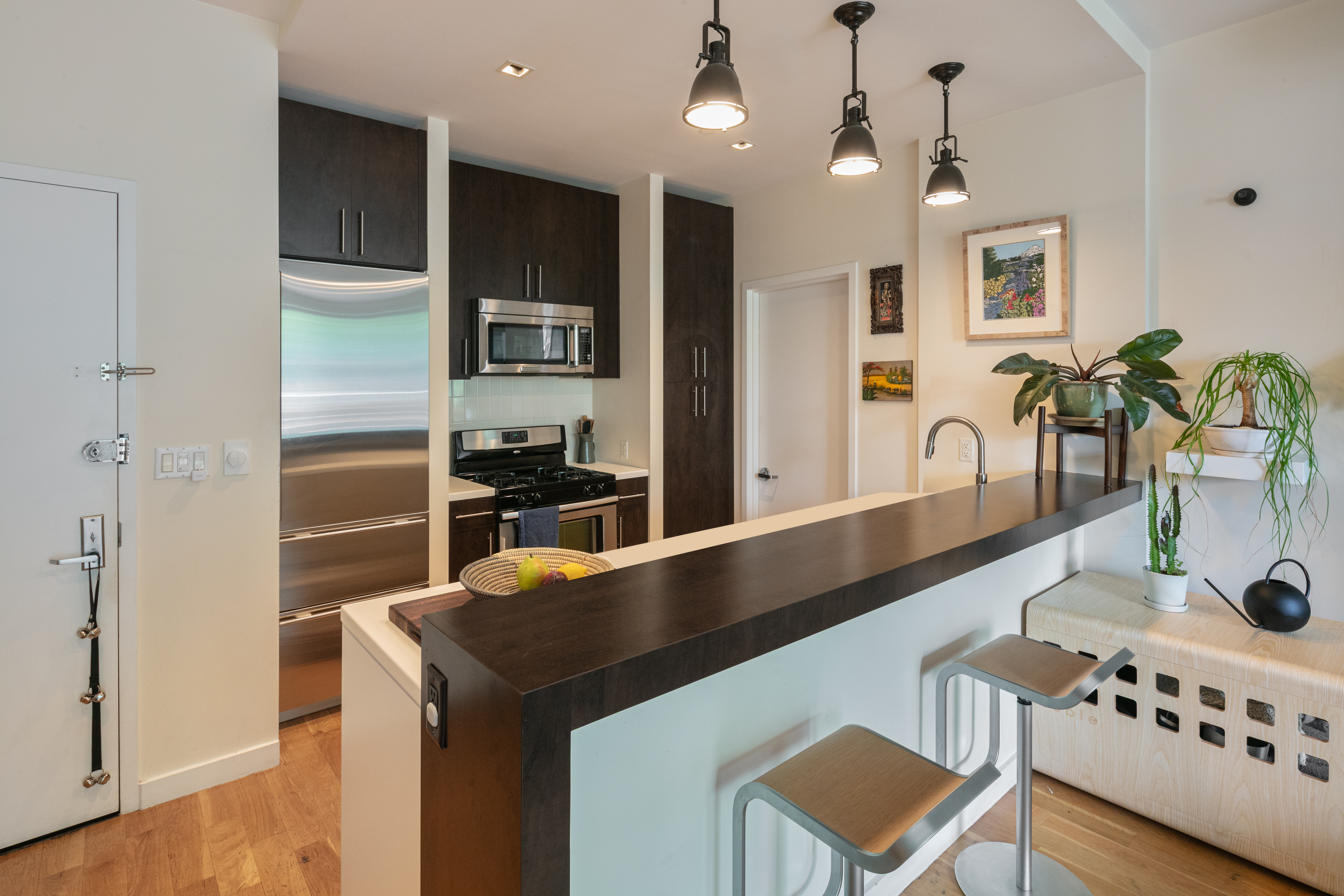 111 Monroe Street, Unit 4B Brooklyn, NY 11216 - Photo 4 of 8 a kitchen with kitchen island a counter space a sink and appliances