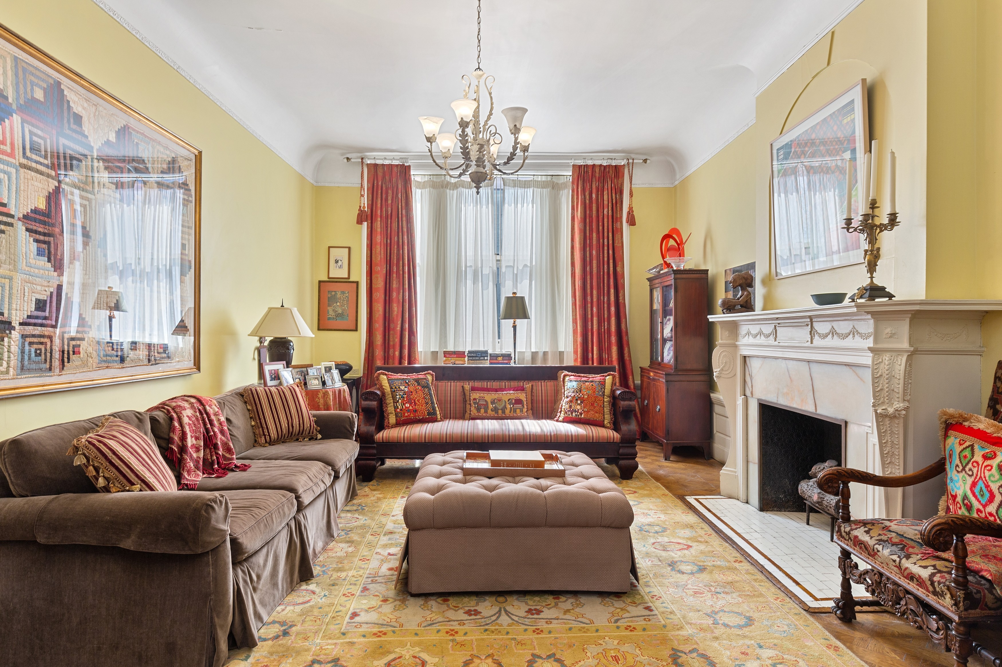 333 West 71st Street Manhattan, NY 10023 - Photo 3 of 29 a living room with furniture a fireplace and a chandelier