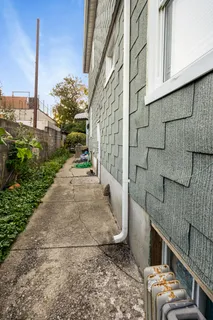 a pathway of a house with a yard