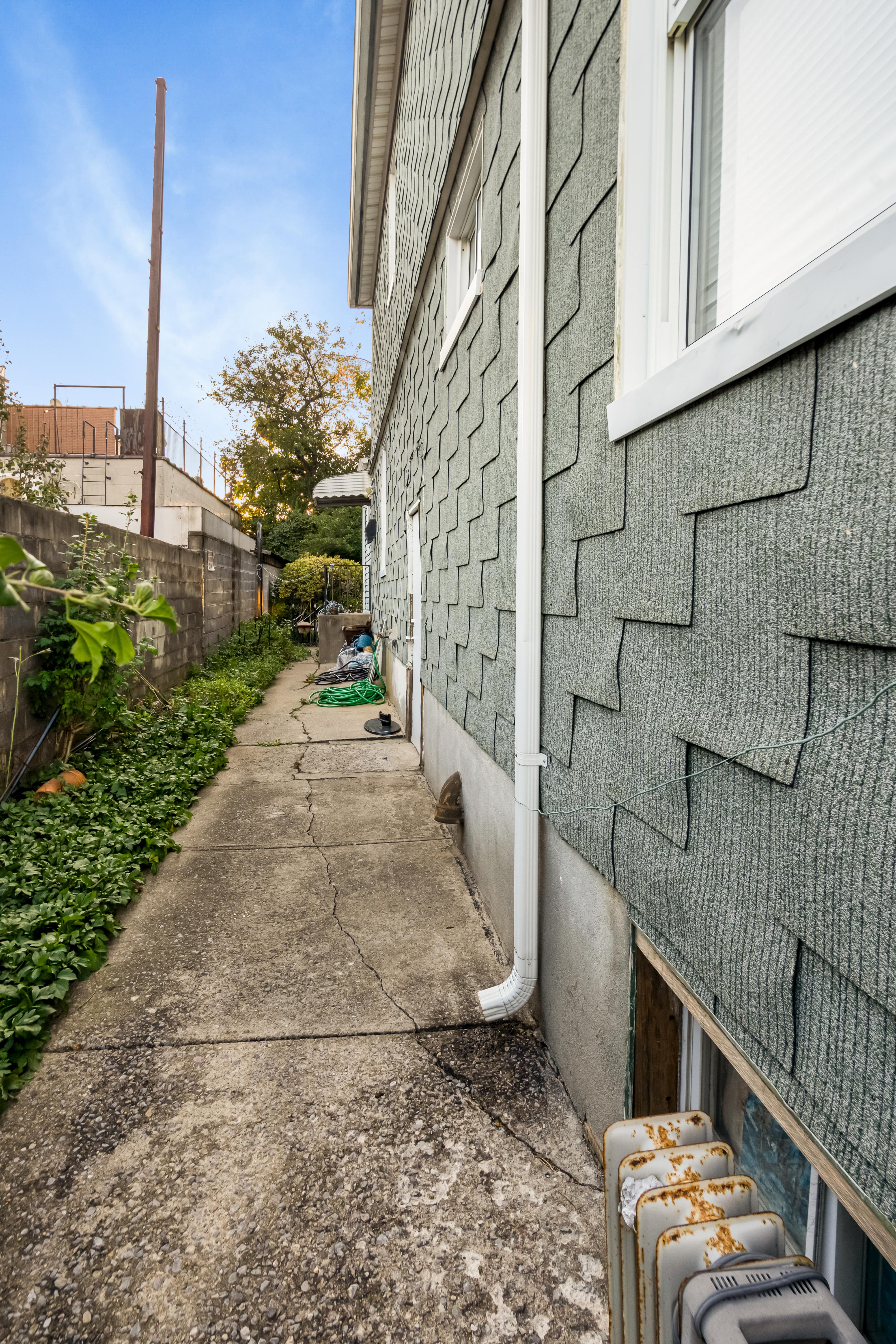 97-30 127th Street Queens, NY 11419 - Photo 16 of 27 a pathway of a house with a yard