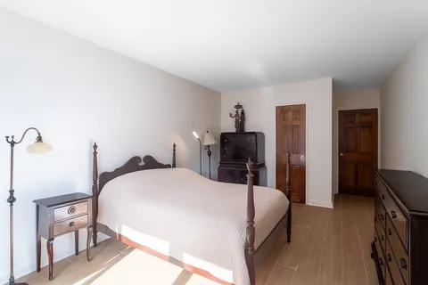 a bedroom with a bed and a desk