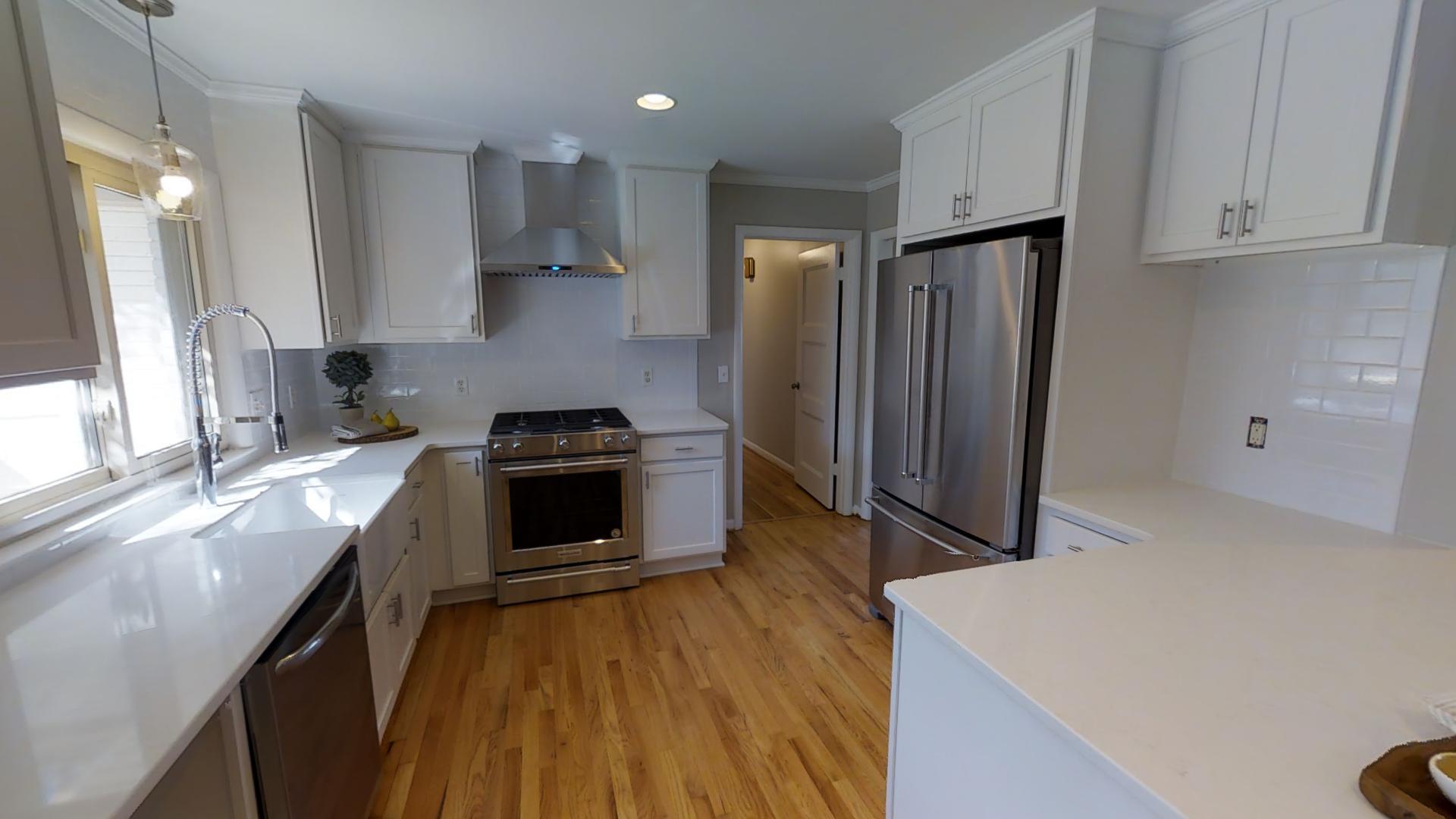 4425 Prescott Road Nashville, TN 37204 - Photo 7 of 26 a kitchen with granite countertop a stove a sink a refrigerator and wooden floor