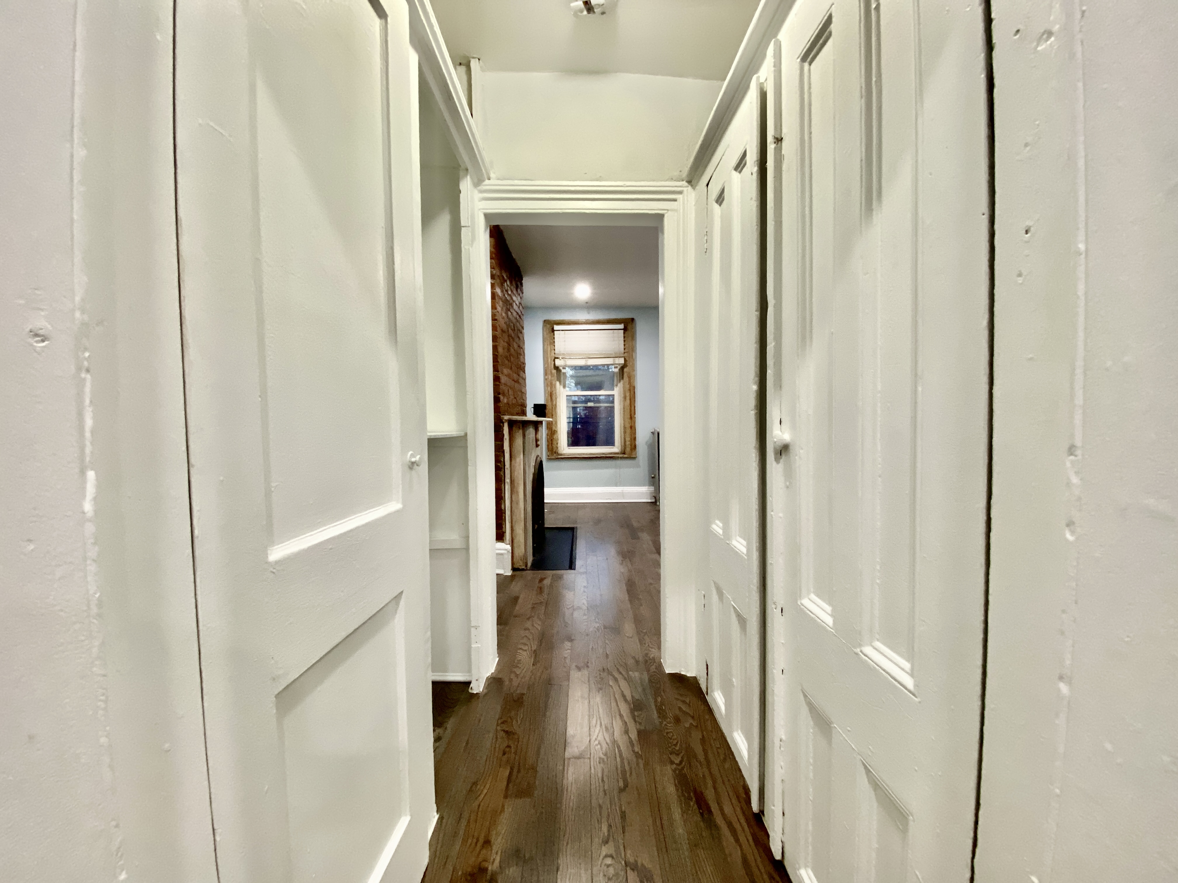 398 Decatur Street, Unit 3 Brooklyn, NY 11233 - Photo 5 of 9 a view of a hallway with wooden floor and staircase