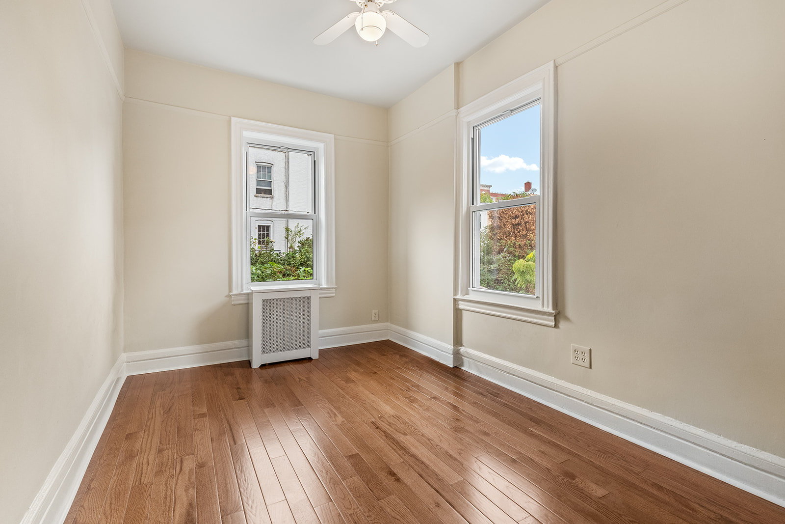181 Terrace Place Brooklyn, NY 11218 - Photo 11 of 22 an empty room with wooden floor and windows