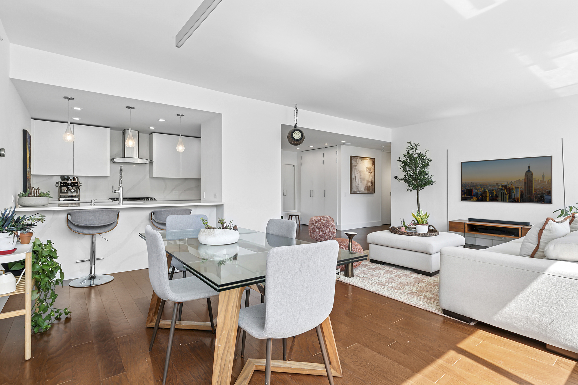 77 Bleecker Street, Unit 1212 Manhattan, NY 10012 - Photo 2 of 9 a living room with furniture and a flat screen tv