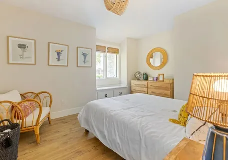 a bedroom with a bed a window and a ceiling fan