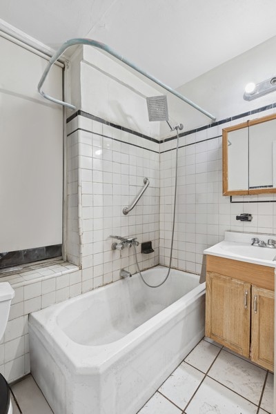 544 West 157th Street, Unit 1 Manhattan, NY 10032 - Photo 5 of 8 a bathroom with a sink and a bathtub
