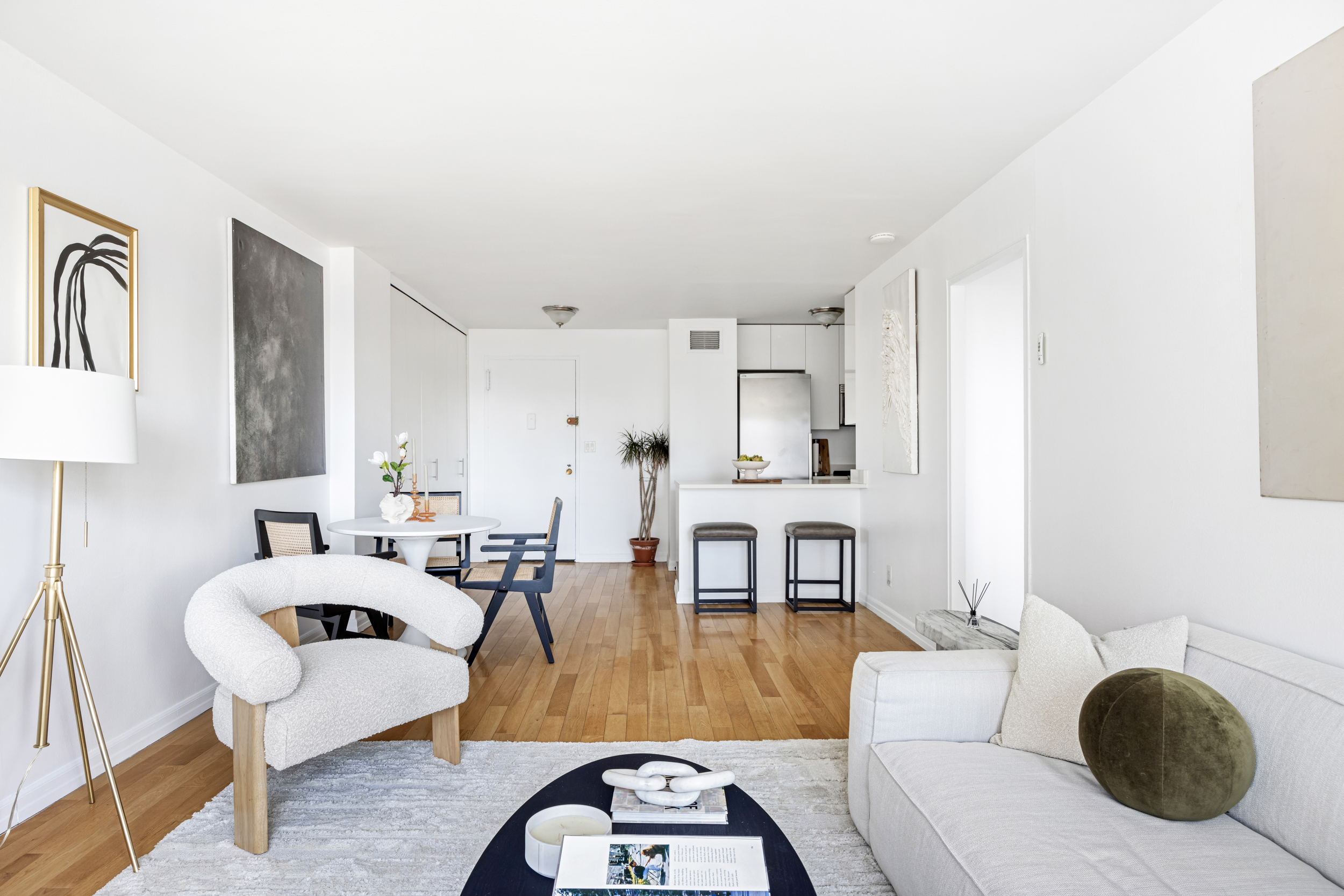 7 East 14th Street, Unit 17G Manhattan, NY 10003 - Photo 3 of 8 a living room with furniture a rug a lamp and a large window