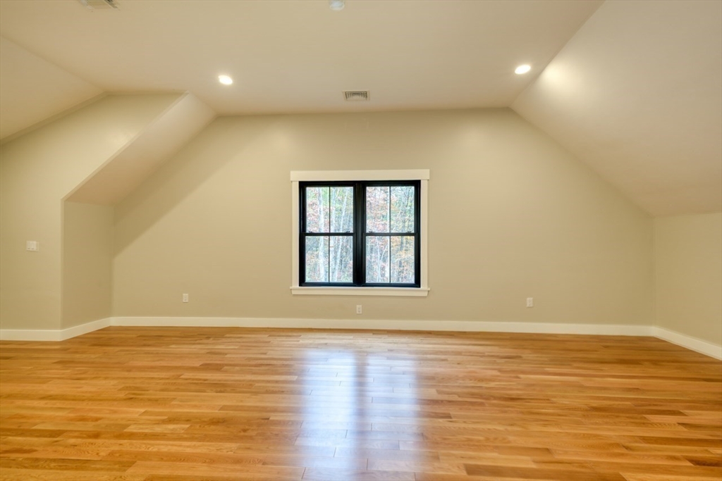 171 Randall Road Berlin, MA 01503 - Photo 23 of 41 a view of an empty room with wooden floor and a window