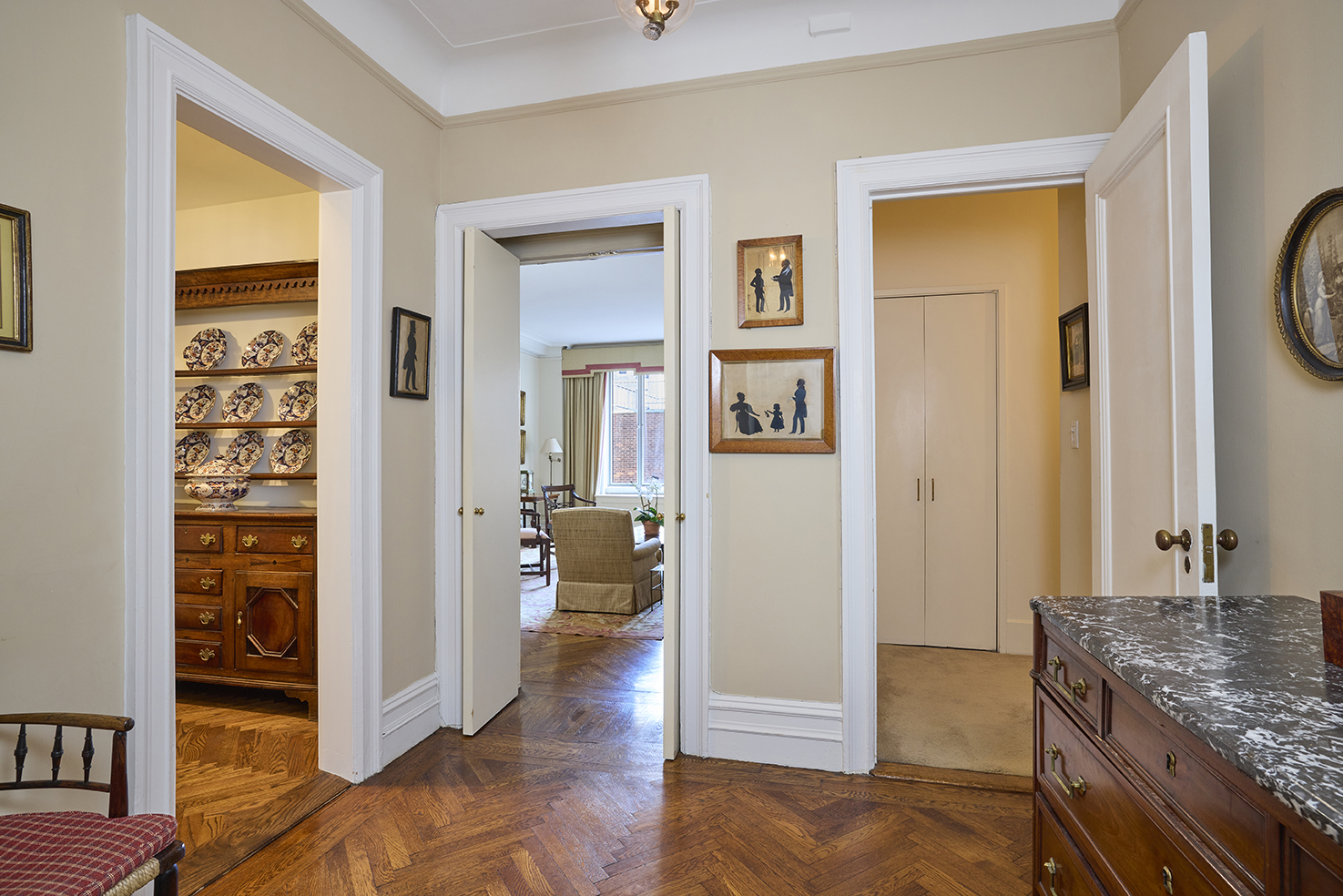161 East 79th Street, Unit 7B Manhattan, NY 10075 - Photo 5 of 15 a view of a livingroom with wooden floor and a bedroom