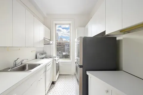 a kitchen with a refrigerator and a sink