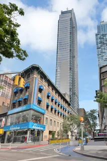 a view of a tall building next to a road