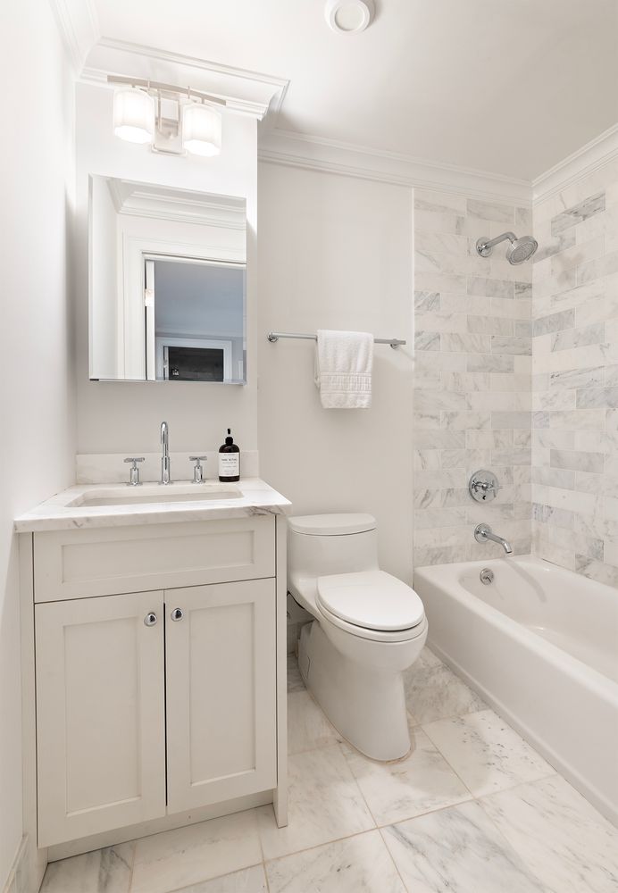 554 East 82nd Street, Unit 1/2 Manhattan, NY 10028 - Photo 9 of 13 a bathroom with a sink a toilet and a mirror