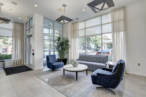 a living room with furniture and a large window
