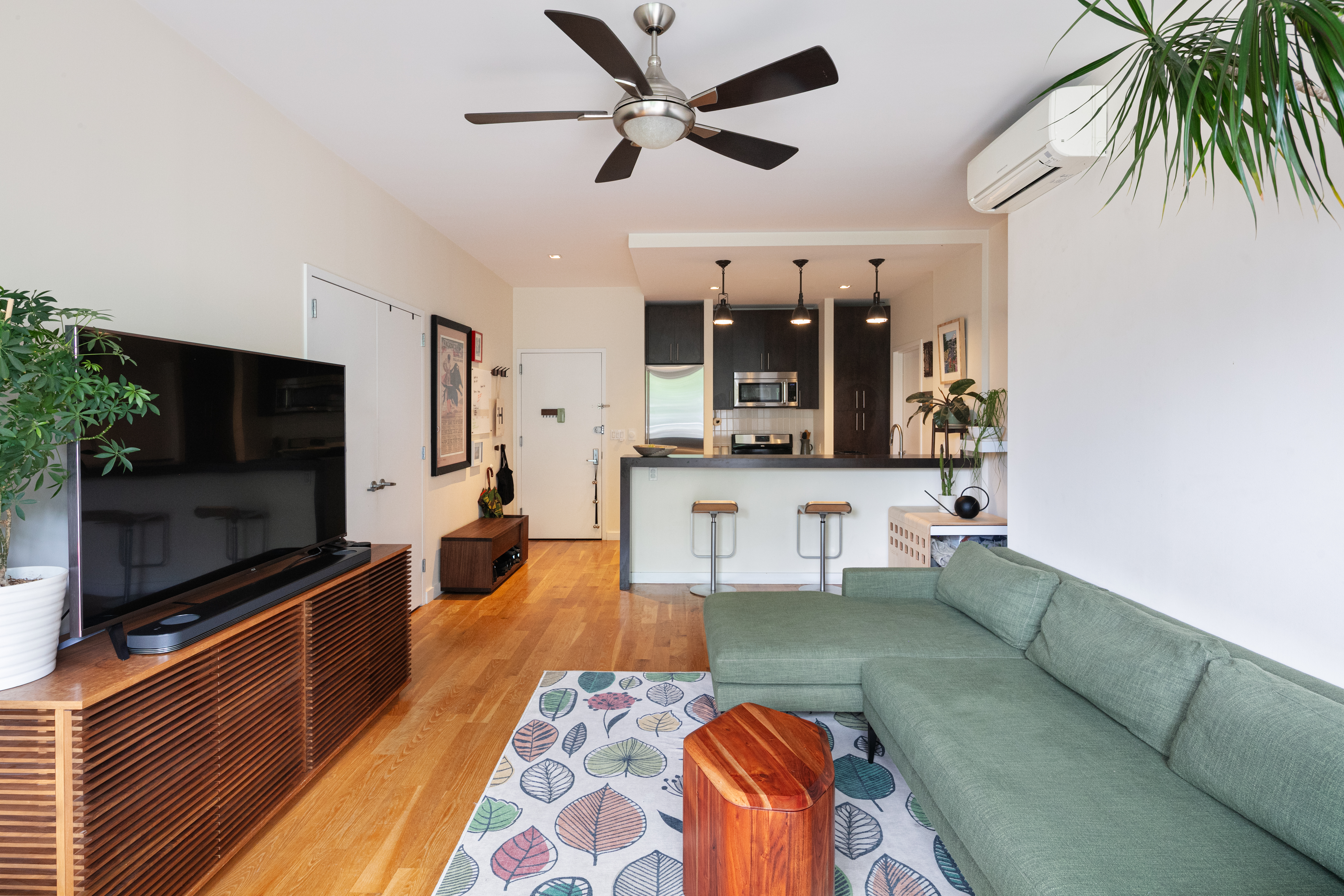 111 Monroe Street, Unit 4B Brooklyn, NY 11216 - Photo 3 of 8 a living room with furniture and a flat screen tv