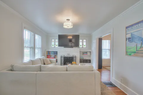 a living room with furniture a fireplace and a flat screen tv
