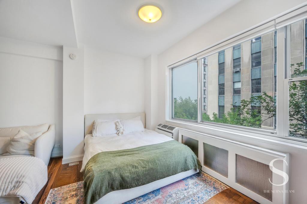7 Lexington Avenue, Unit 5E Manhattan, NY 10010 - Photo 4 of 14 a bedroom with a bed and a window