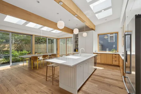 a large white kitchen with a large window