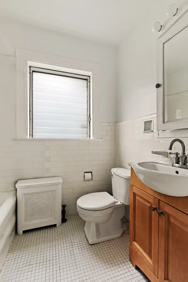 a bathroom with a granite countertop toilet a sink and a mirror
