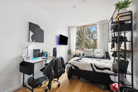 a bedroom with a bed and a flat screen tv