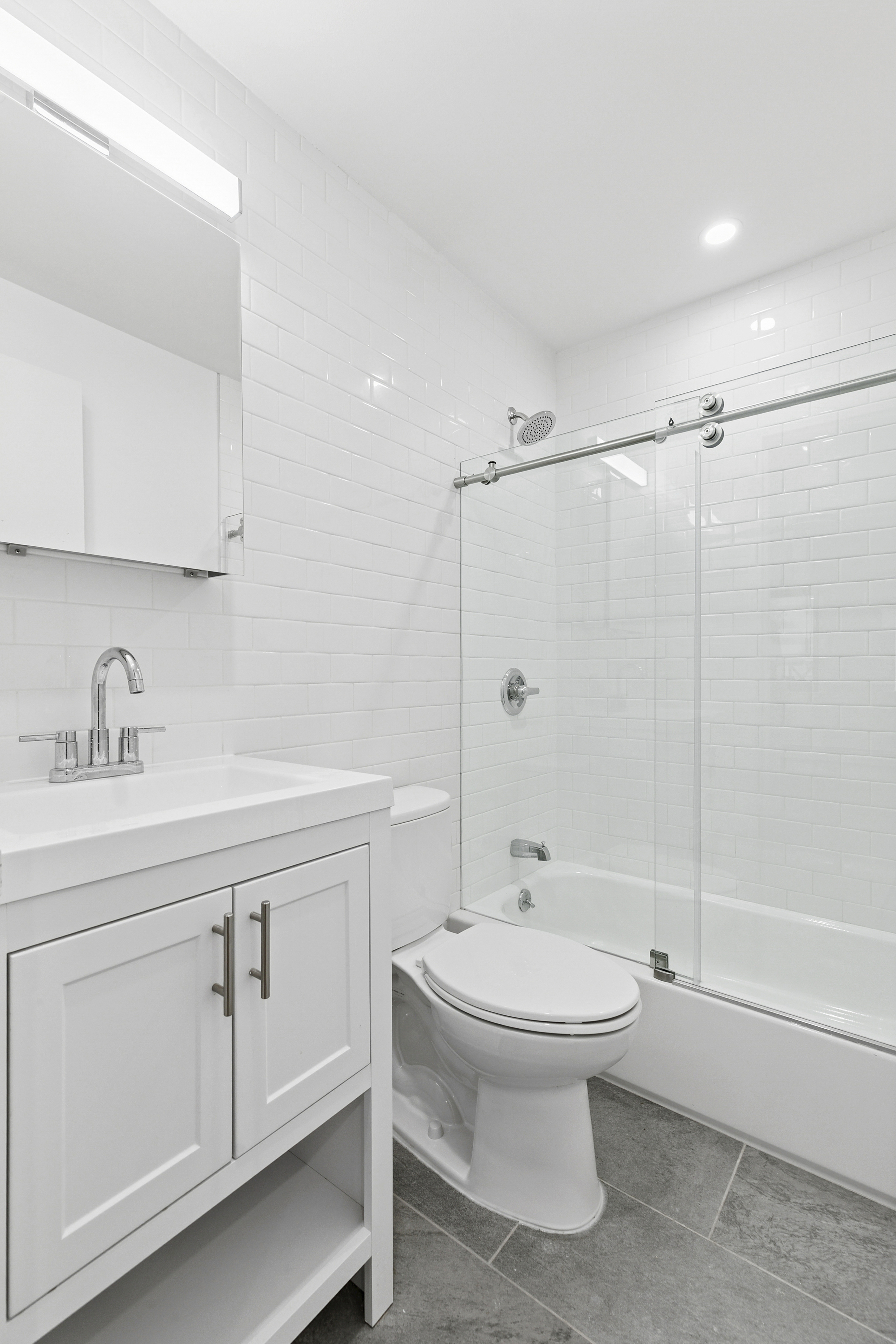 325 West 51st Street, Unit 1A Manhattan, NY 10019 - Photo 4 of 6 a bathroom with a toilet sink and shower