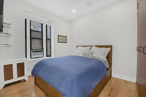 a bedroom with bed and window