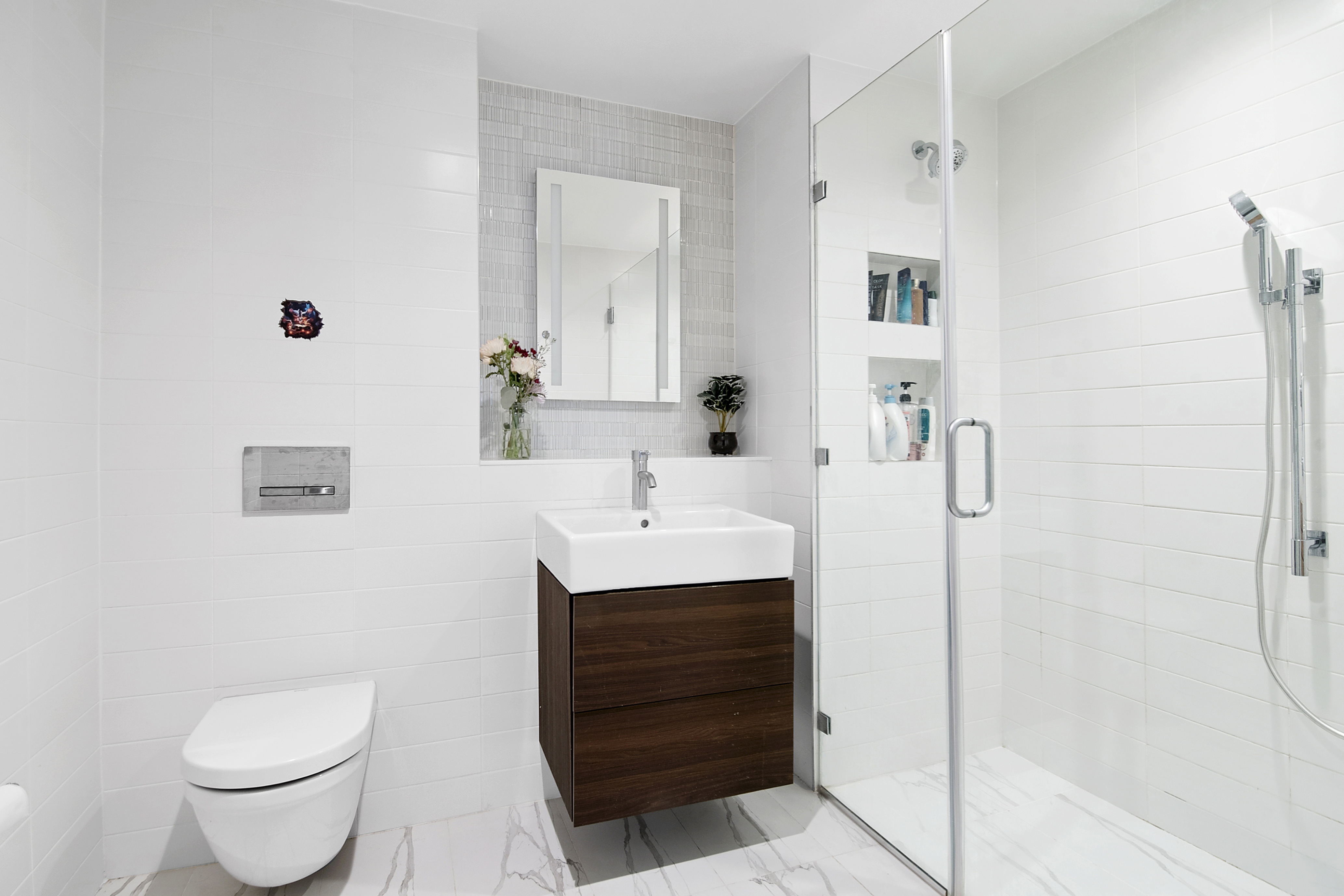 1064 Hancock Street, Unit 101 Brooklyn, NY 11221 - Photo 2 of 9 a bathroom with a sink toilet a mirror and shower