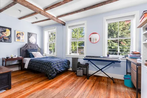 a bedroom with furniture and a wooden floor