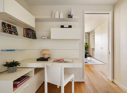 a view of a workspace with furniture and wooden floor
