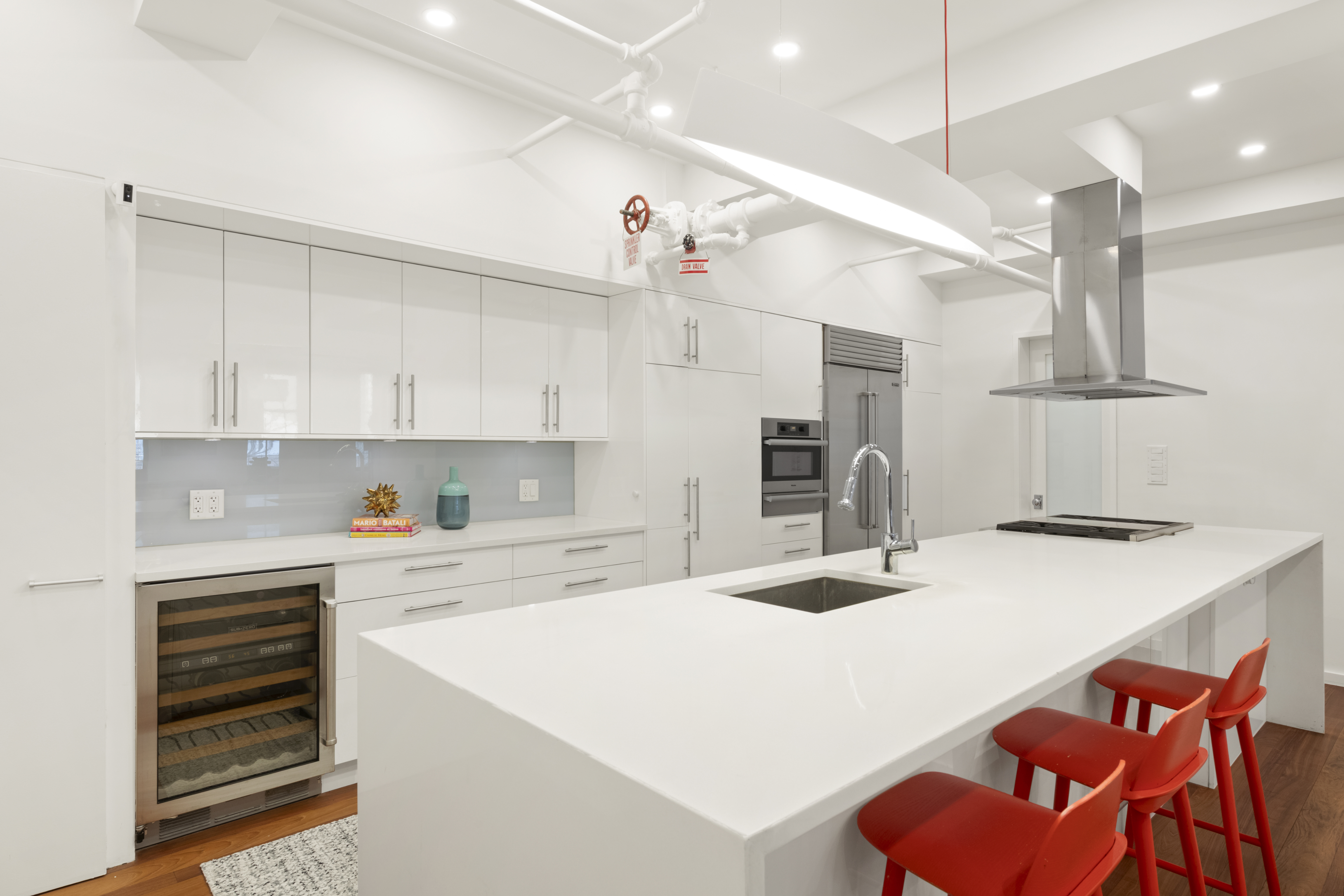 110 Duane Street, Unit 3F Manhattan, NY 10007 - Photo 4 of 14 a kitchen with stainless steel appliances kitchen island a table chairs sink and cabinets