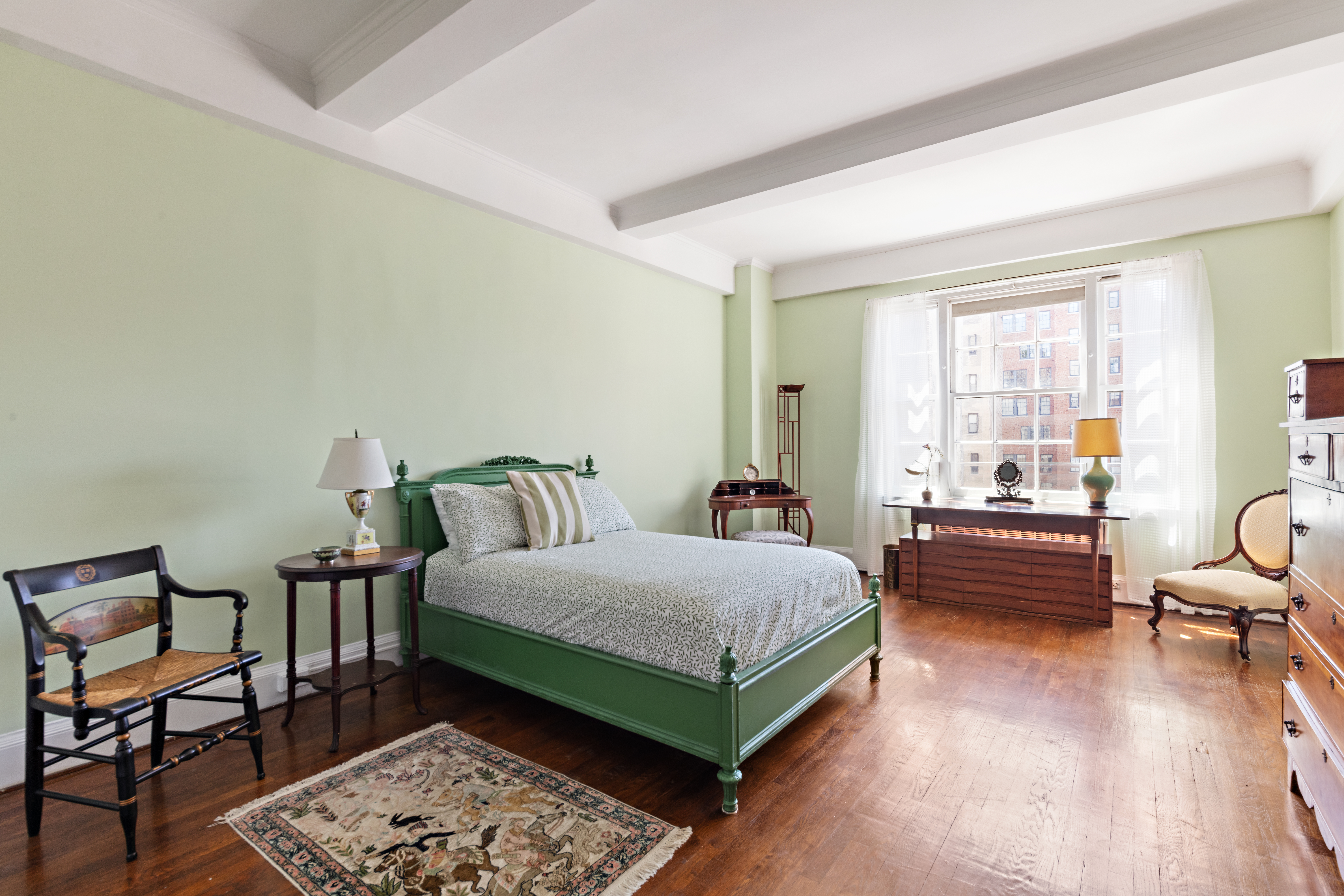 151 East 79th Street Manhattan, NY 10075 - Photo 10 of 15 a bedroom with a bed and wooden floor