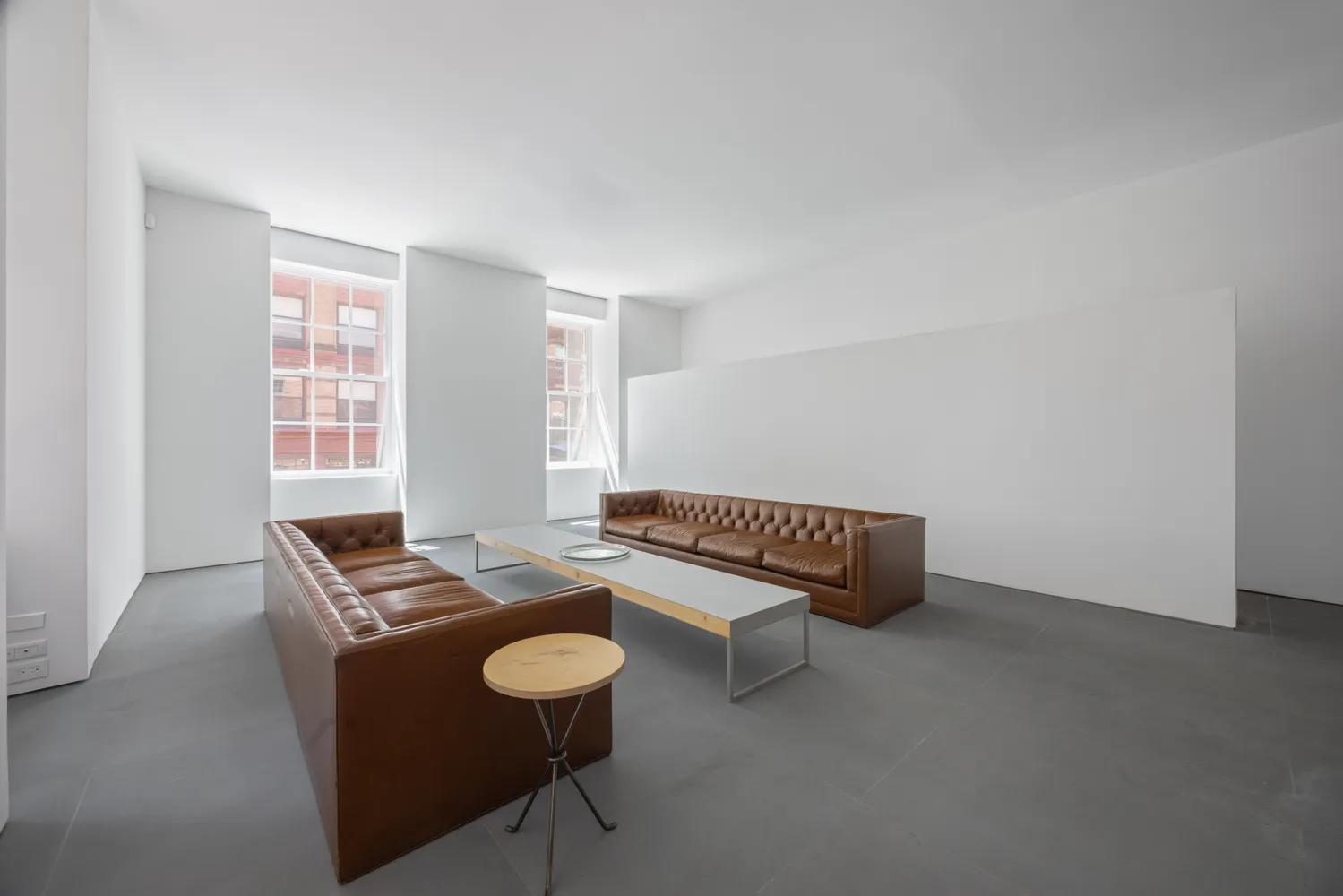 a view of workspace with furniture and window