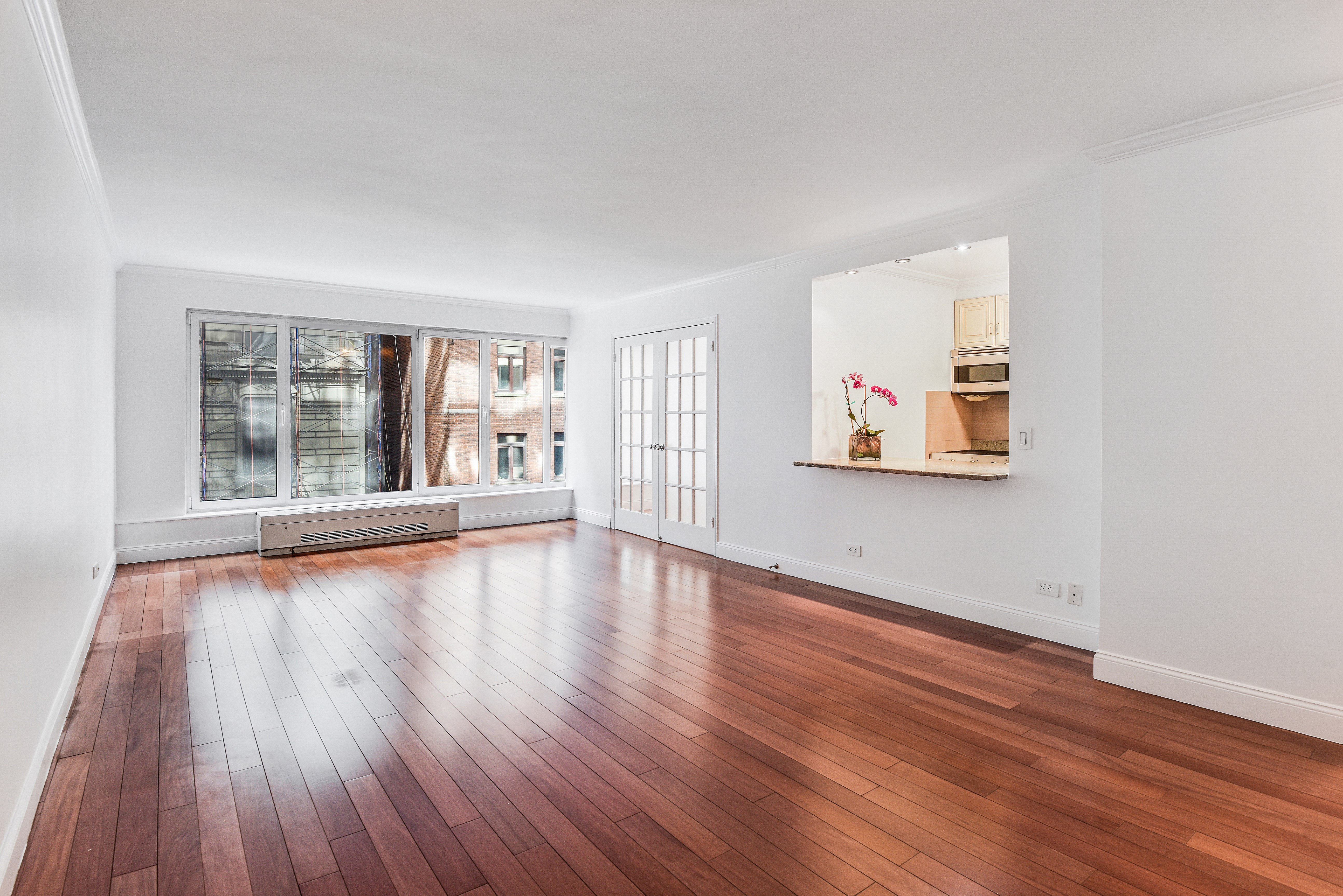 200 Central Park South, Unit 5M Manhattan, NY 10019 - Photo 5 of 15 a view of an empty room with wooden floor and a window