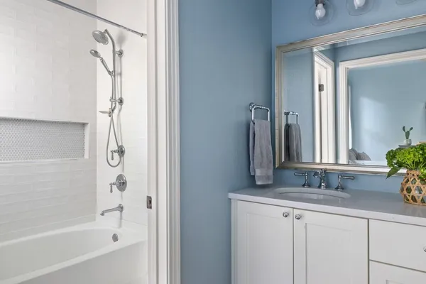 a bathroom with a granite countertop sink and a mirror